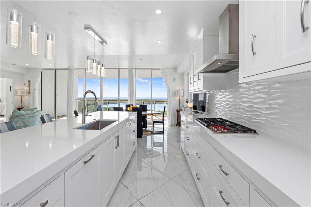 13945 Old Coast Road, Unit 806 Naples, FL 34110 - Photo 8 of 50 a kitchen with stainless steel appliances a sink a stove and cabinets