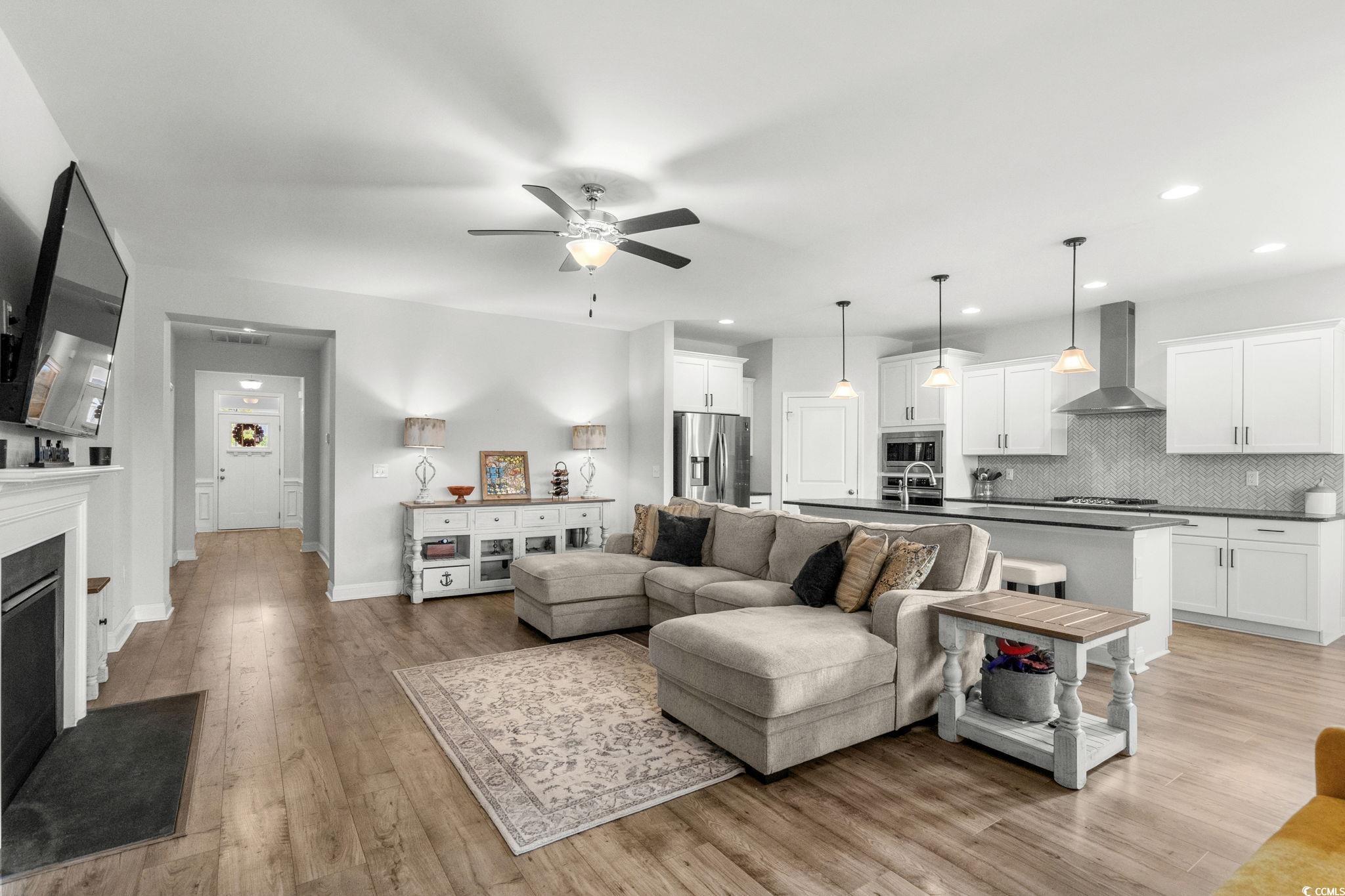 506 Indigo Bay Circle Myrtle Beach, SC 29579 - Photo 11 of 40 Living room featuring light wood finished floors, a fireplace, a ceiling fan, and recessed lighting