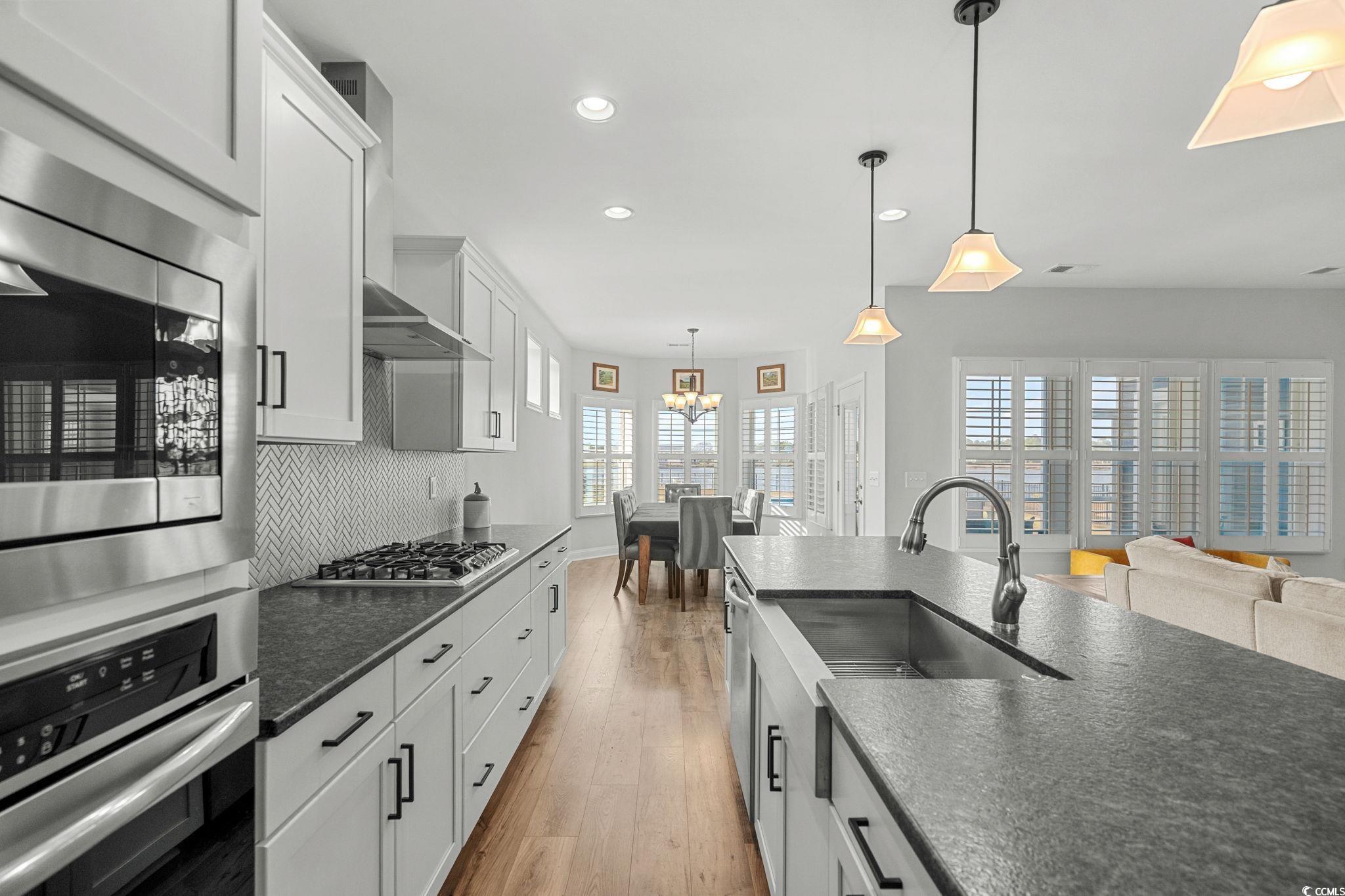 506 Indigo Bay Circle Myrtle Beach, SC 29579 - Photo 40 of 40 Kitchen featuring stainless steel appliances, decorative light fixtures, recessed lighting, white cabinets, and open floor plan