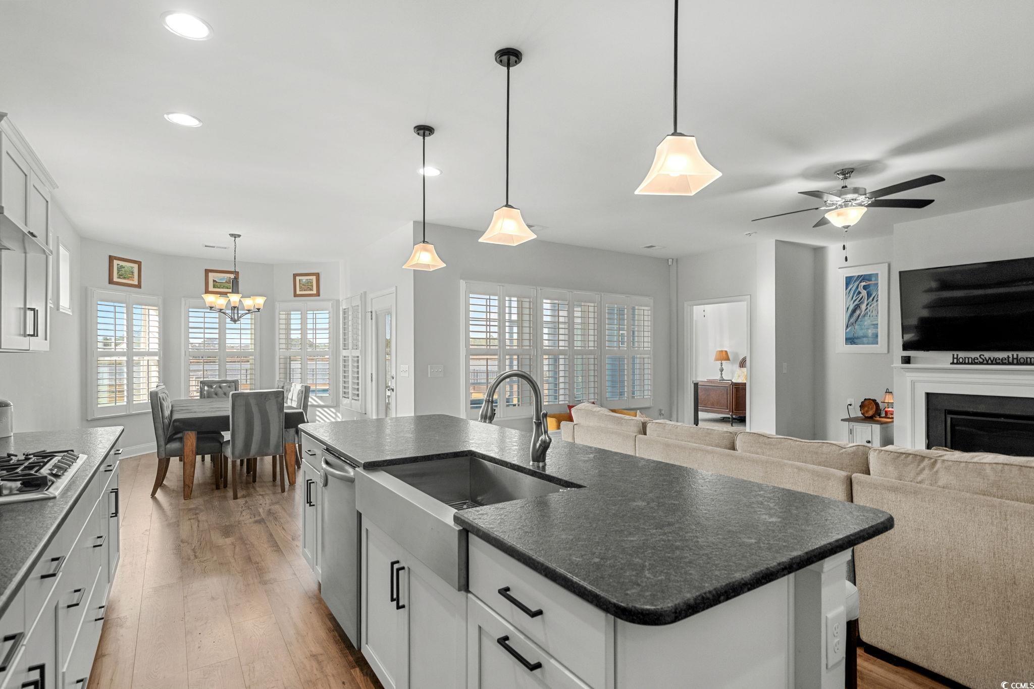 506 Indigo Bay Circle Myrtle Beach, SC 29579 - Photo 15 of 40 Kitchen with decorative light fixtures, dark countertops, white cabinets, a center island with sink, and recessed lighting