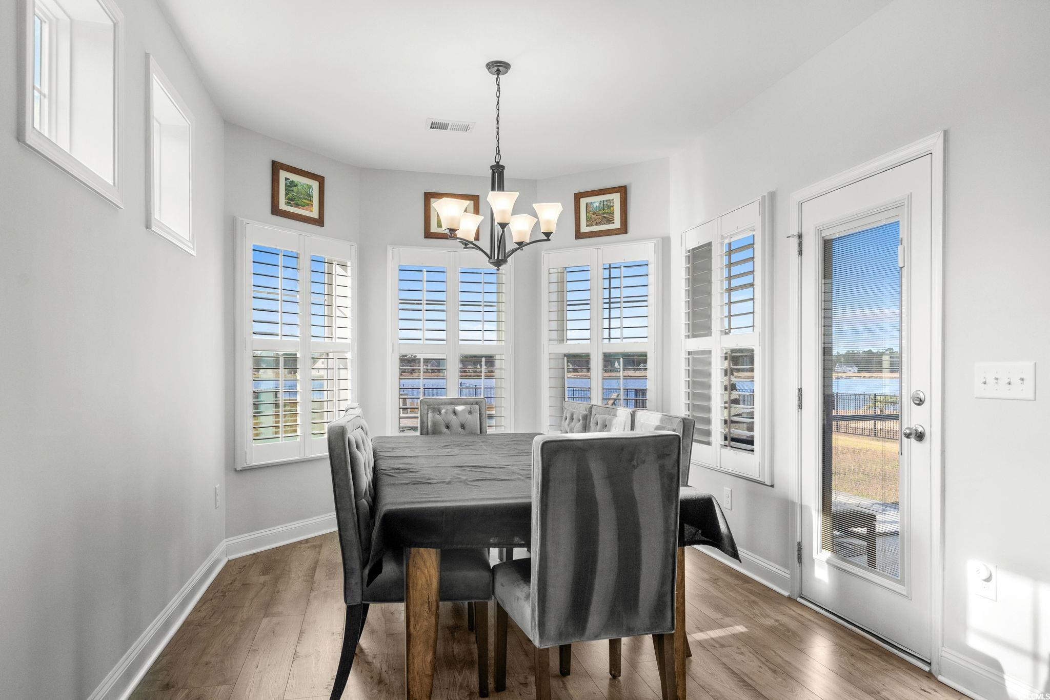 506 Indigo Bay Circle Myrtle Beach, SC 29579 - Photo 16 of 40 Dining area featuring wood-type flooring and a chandelier