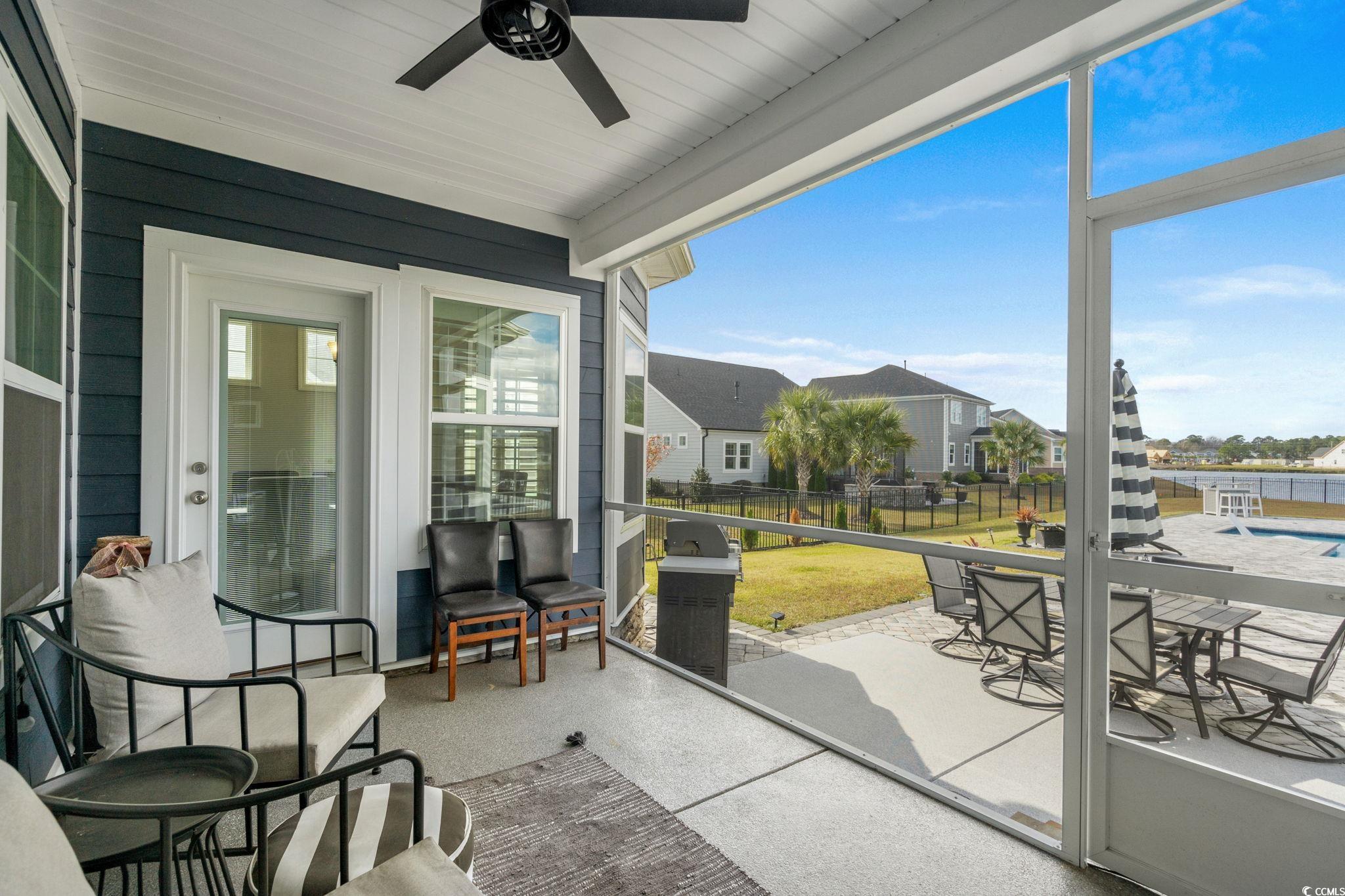 506 Indigo Bay Circle Myrtle Beach, SC 29579 - Photo 17 of 40 Sunroom / solarium with outdoor dining area, a patio, and ceiling fan