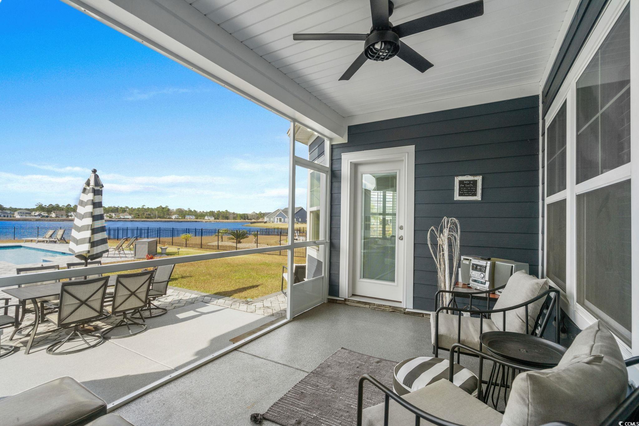 506 Indigo Bay Circle Myrtle Beach, SC 29579 - Photo 18 of 40 Sunroom / solarium with a water view, a ceiling fan, outdoor dining space, and a patio