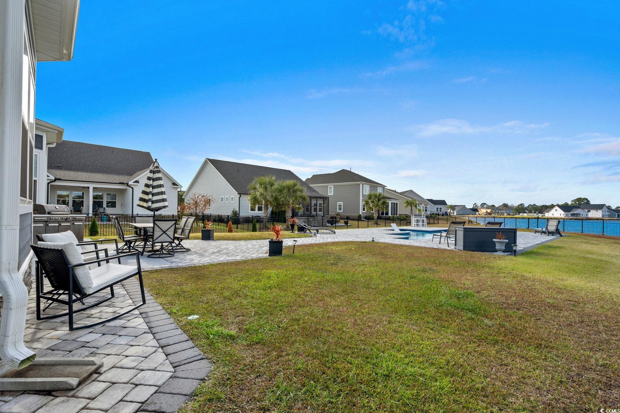 506 Indigo Bay Circle Myrtle Beach, SC 29579 - Photo 19 of 40 Fenced backyard featuring a patio area, an outdoor pool, and a residential view