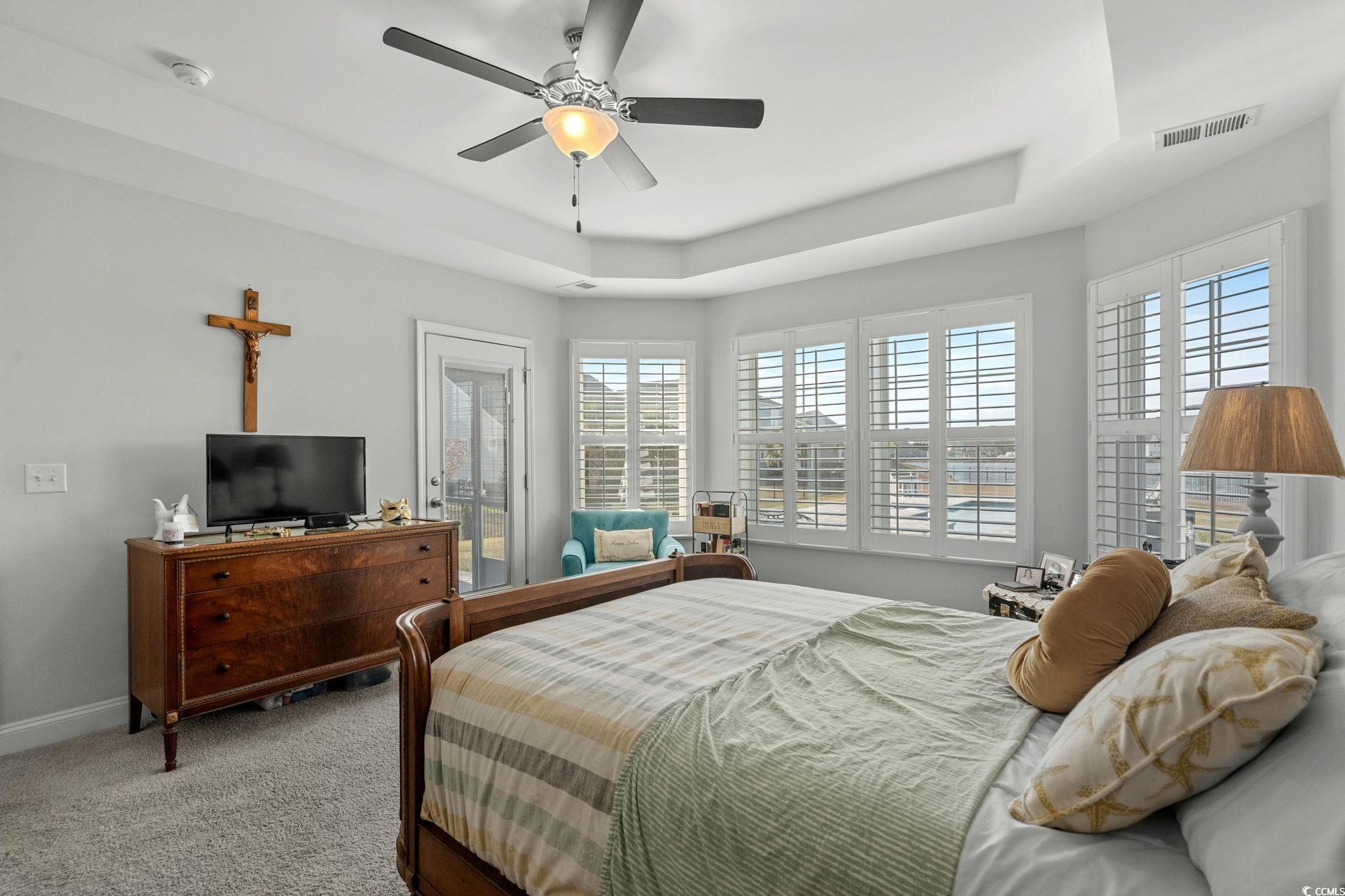 506 Indigo Bay Circle Myrtle Beach, SC 29579 - Photo 22 of 40 Carpeted bedroom featuring access to outside, a tray ceiling, and ceiling fan