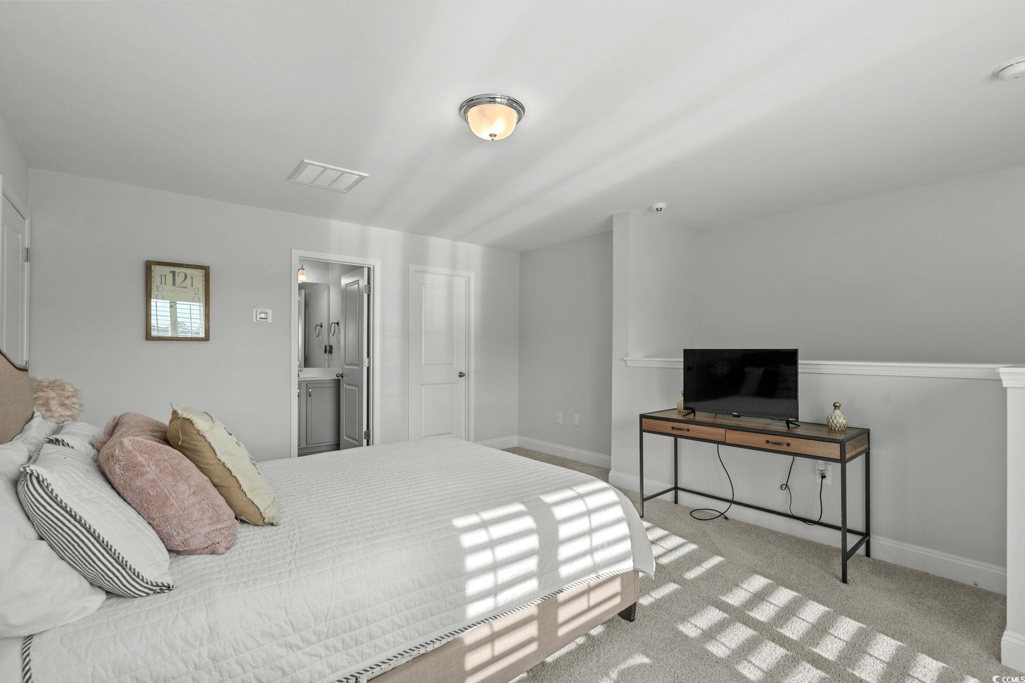 506 Indigo Bay Circle Myrtle Beach, SC 29579 - Photo 30 of 40 Bedroom with light carpet and ensuite bathroom