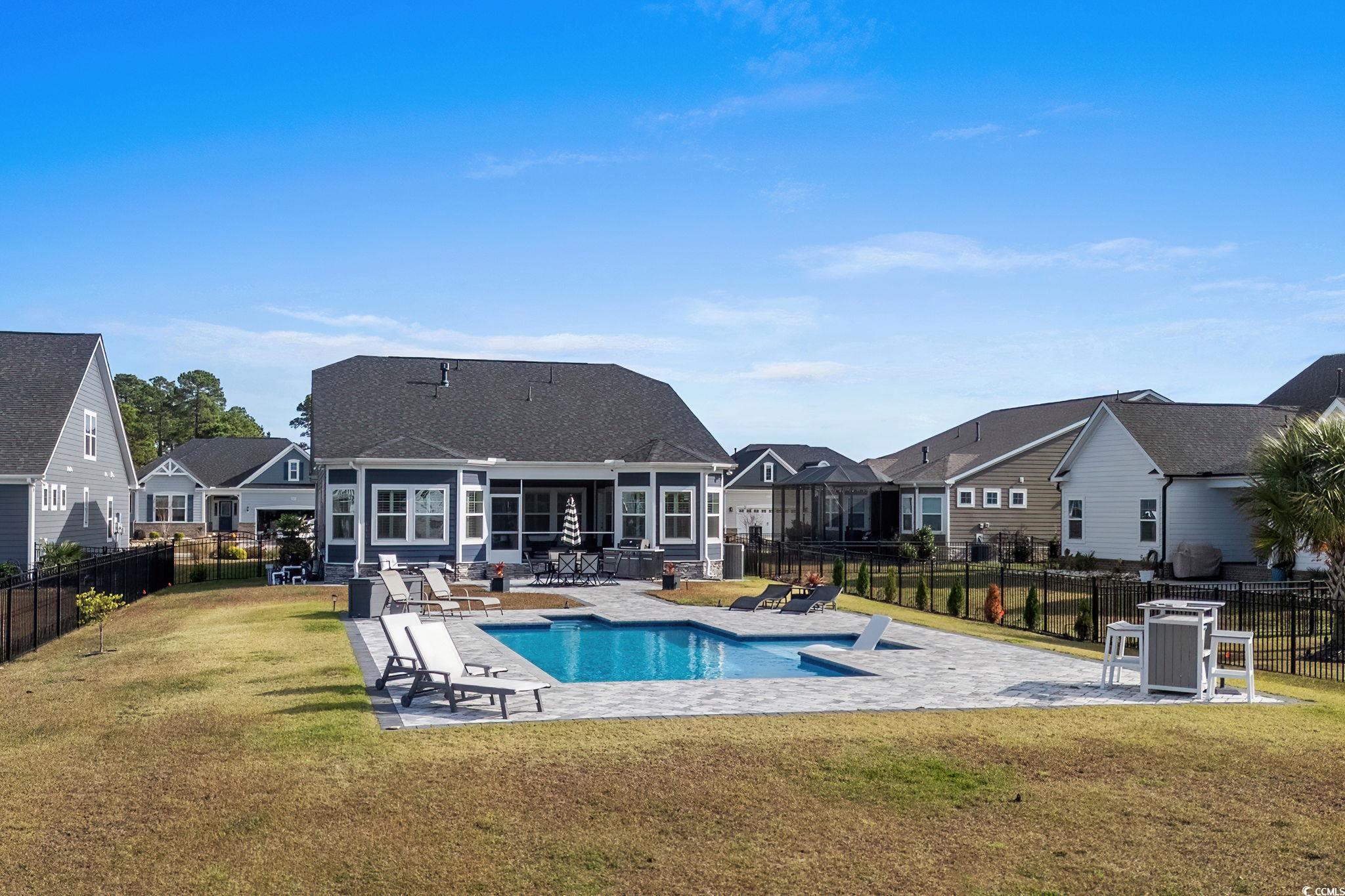 506 Indigo Bay Circle Myrtle Beach, SC 29579 - Photo 4 of 40 View of swimming pool featuring a patio area, a residential view, and a fenced backyard