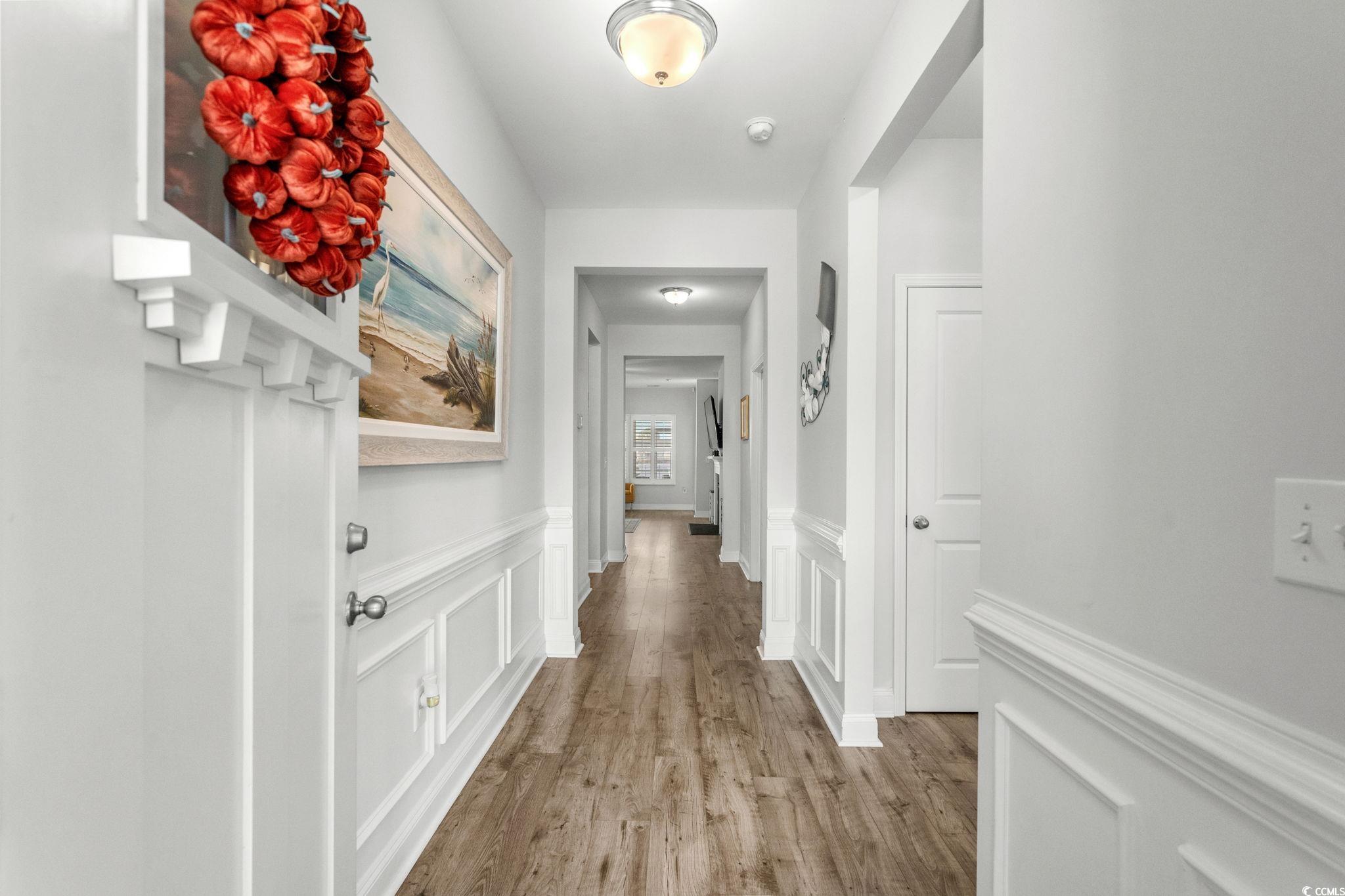506 Indigo Bay Circle Myrtle Beach, SC 29579 - Photo 6 of 40 Corridor with a wainscoted wall, a decorative wall, and light wood-style flooring