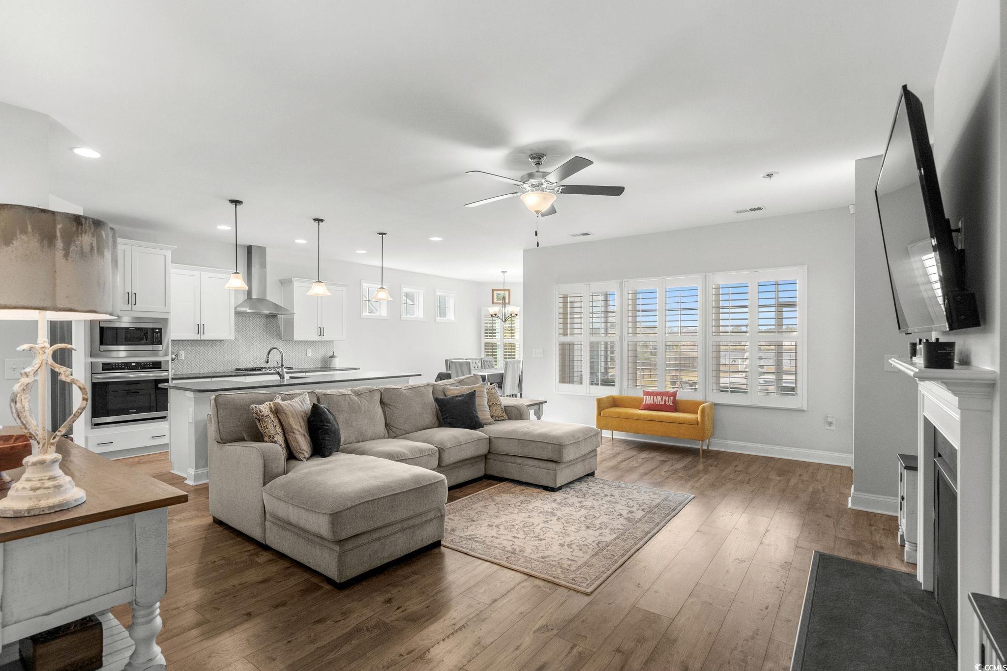 506 Indigo Bay Circle Myrtle Beach, SC 29579 - Photo 7 of 40 Living room featuring ceiling fan, wood-type flooring, a fireplace with flush hearth, and recessed lighting
