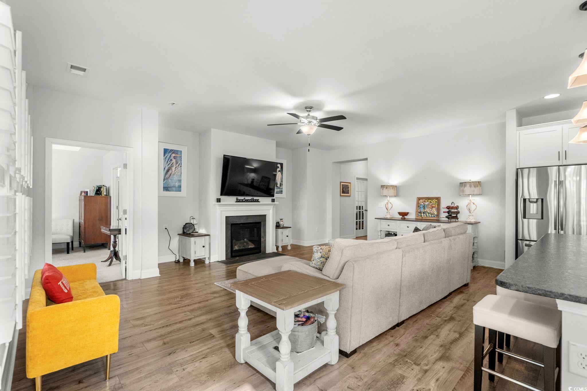 506 Indigo Bay Circle Myrtle Beach, SC 29579 - Photo 9 of 40 Living area with a fireplace with flush hearth, a ceiling fan, and light wood finished floors