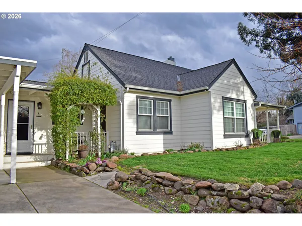 a front view of a house with a yard and porch