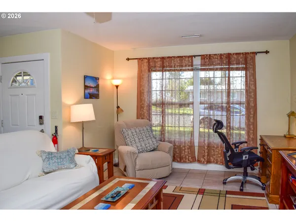 a living room with furniture and a floor to ceiling window