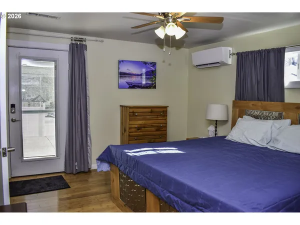 a bedroom with a bed dresser and a window