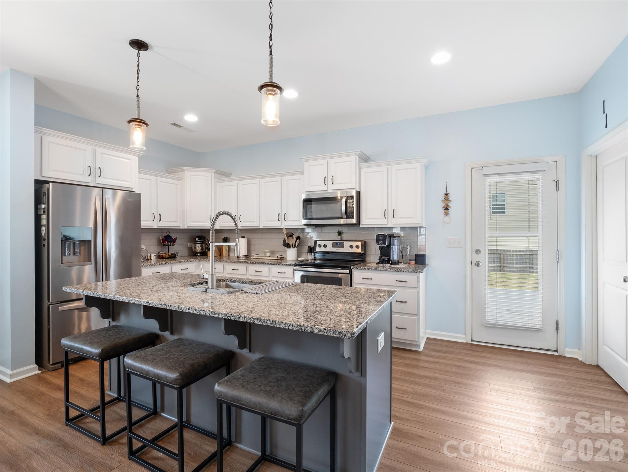 629 Gants Road York, SC 29745 - Photo 3 of 27 a kitchen with stainless steel appliances granite countertop a sink a stove a refrigerator cabinets and chairs