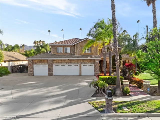 a house with lots of trees in the background