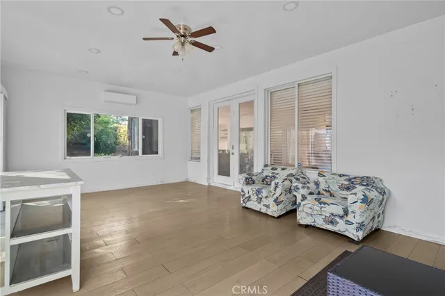 a bedroom with a bed and glass door