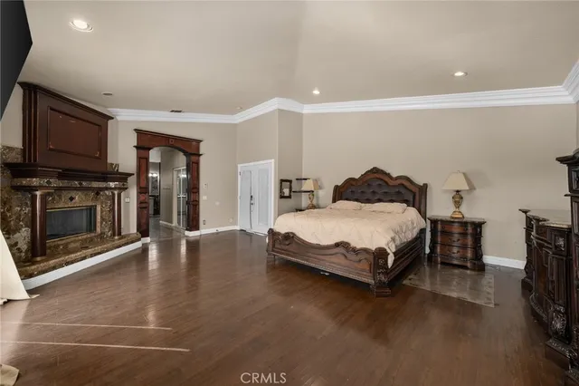 a bedroom with furniture and a flat screen tv