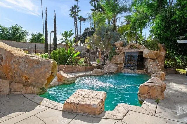 a bathroom with a granite countertop sink a mirror and shower