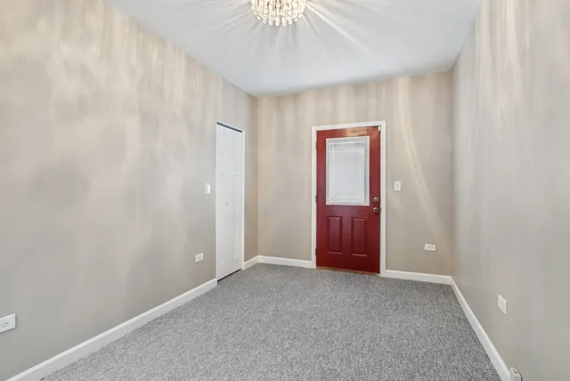 an empty room with closet and entryway