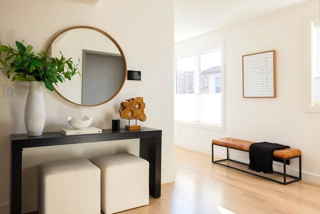 a living room with furniture and a mirror