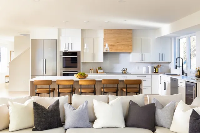 a living room with furniture kitchen view and a window