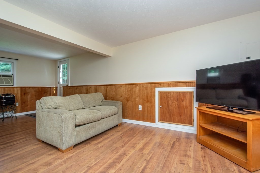 72 Peabody Road Shirley, MA 01464 - Photo 20 of 39 a living room with a couch and a flat screen tv