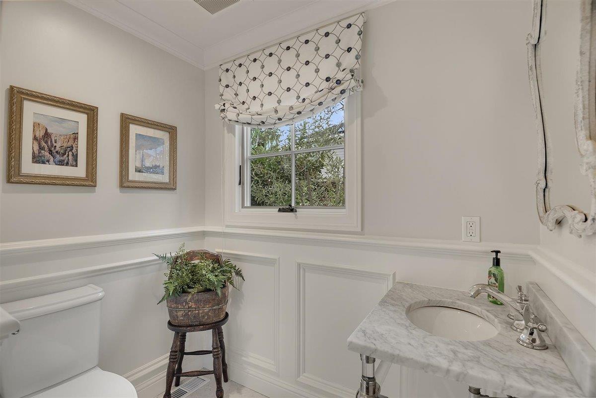 593 Sleeper Avenue Mountain View, CA 94040 - Photo 42 of 56 a bathroom with a granite countertop sink a toilet and a window