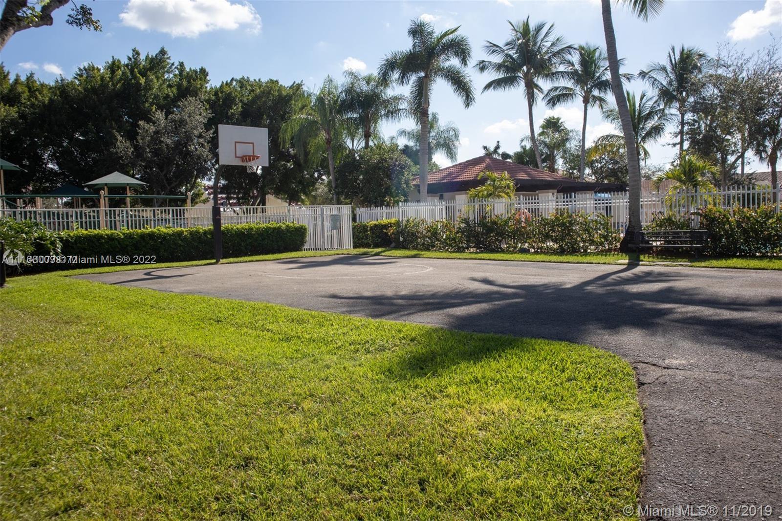 Weston Weston, FL 33326 - Photo 24 of 25 a view of a house with a yard and palm trees
