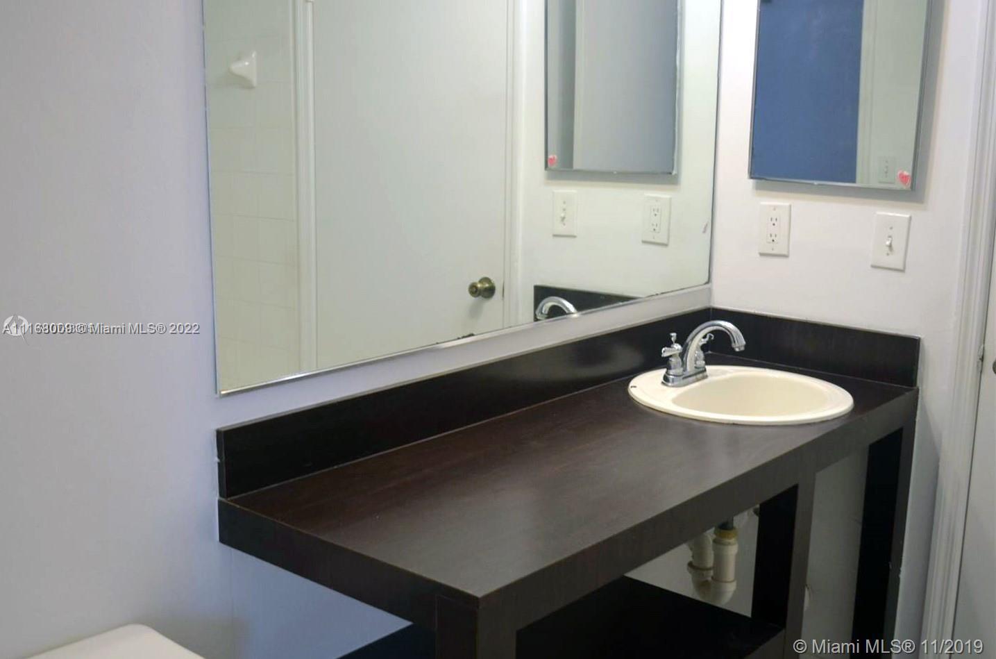Weston Weston, FL 33326 - Photo 8 of 25 a bathroom with a sink and a mirror