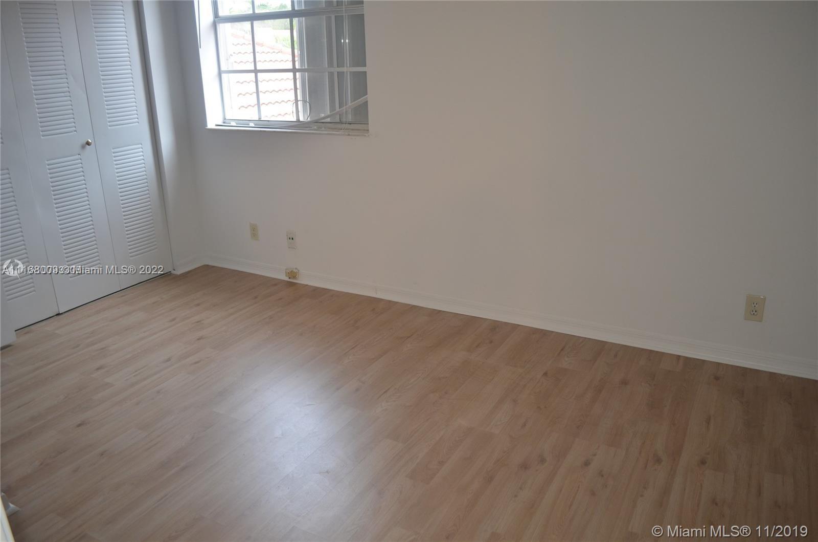 Weston Weston, FL 33326 - Photo 10 of 25 an empty room with wooden floor and windows