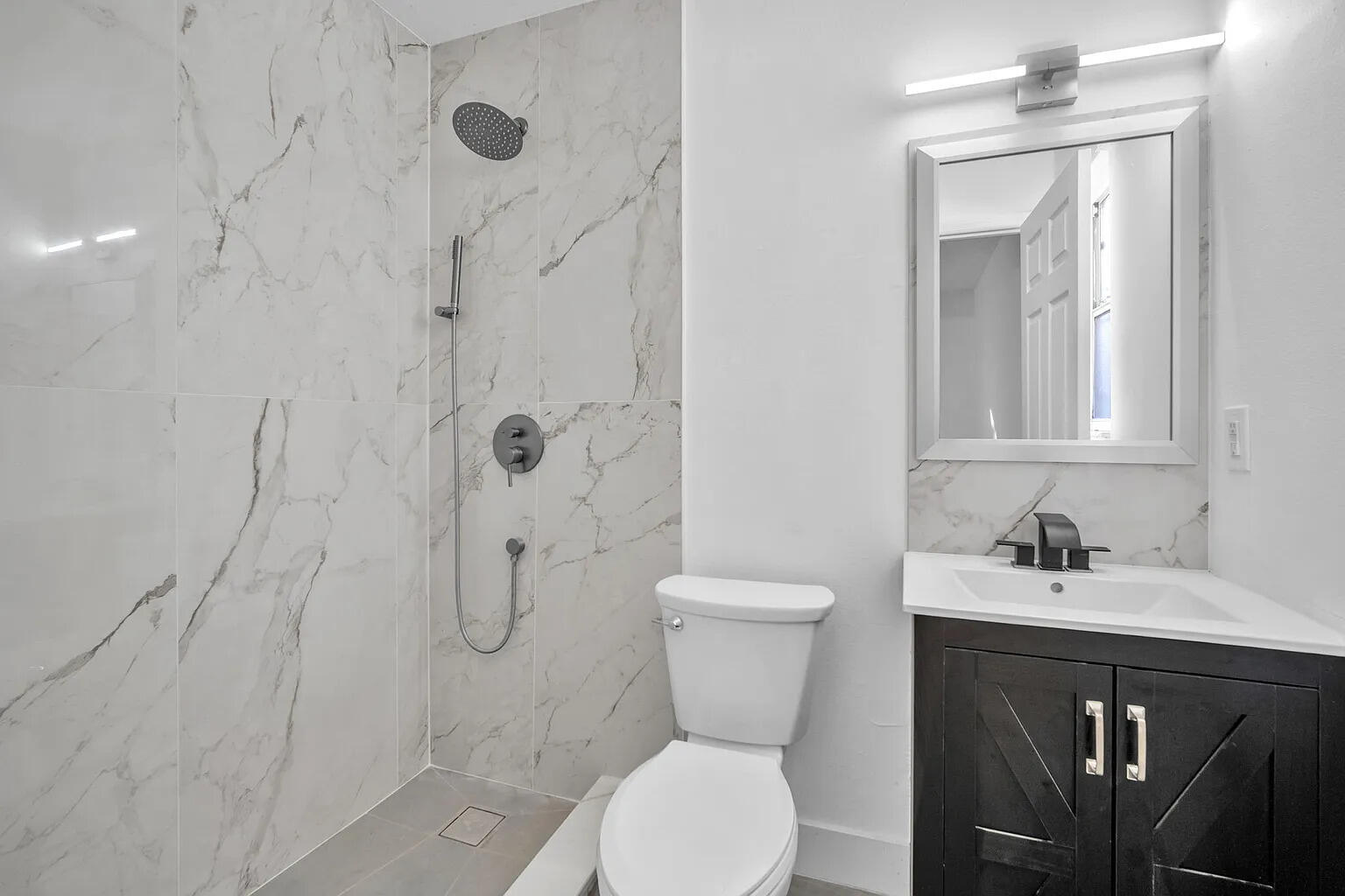 719 Southwest 10th Street Florida City, FL 33034 - Photo 6 of 13 a bathroom with a sink toilet and shower