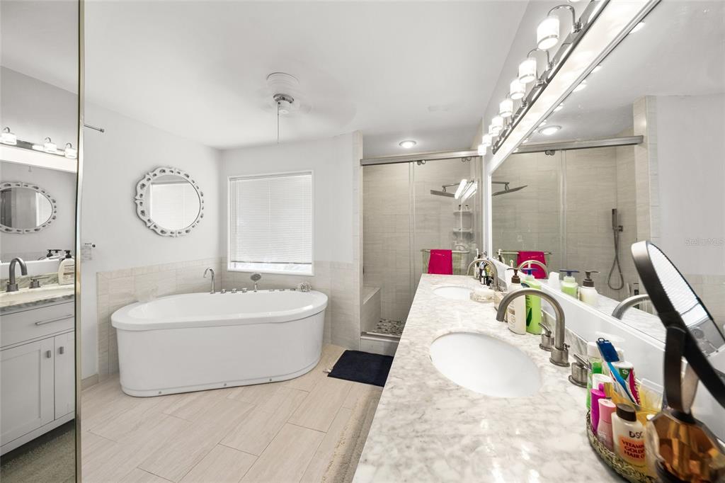 3421 Bayou Sound Longboat Key, FL 34228 - Photo 26 of 79 a en suite spacious bathroom with a tub sink and a mirror