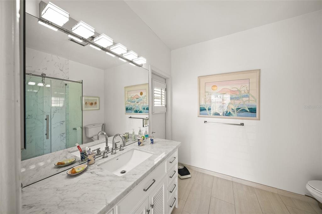 3421 Bayou Sound Longboat Key, FL 34228 - Photo 36 of 79 a bathroom with a sink and a mirror