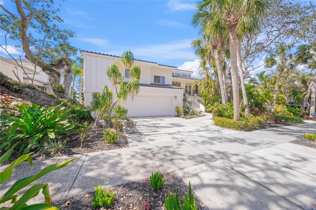 3421 Bayou Sound Longboat Key, FL 34228 - Photo 6 of 79 a street view with potted plants and large trees