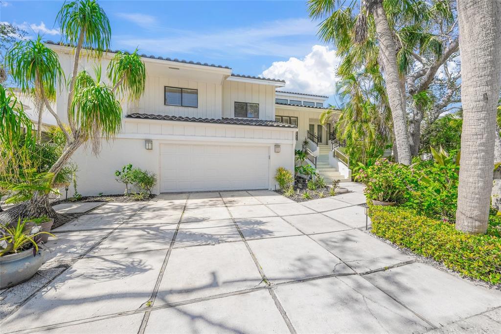 3421 Bayou Sound Longboat Key, FL 34228 - Photo 7 of 79 a white house with a small yard and a large space