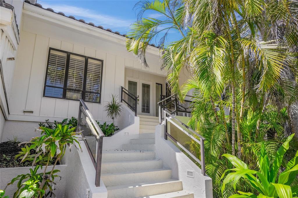 3421 Bayou Sound Longboat Key, FL 34228 - Photo 8 of 79 a view of a house with a yard and potted plants