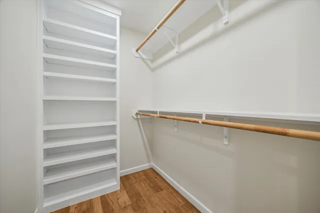 a view of walk in closet with empty racks