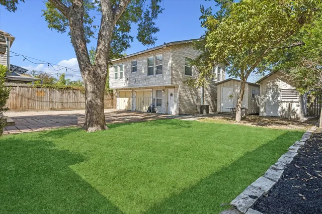 a large tree in front of a house