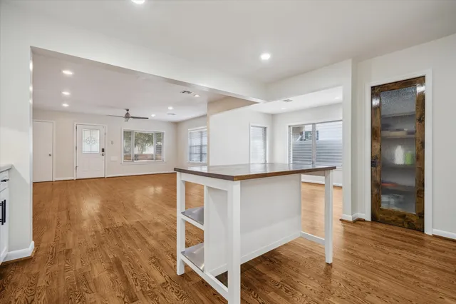 a view of kitchen and hall with wooden floor