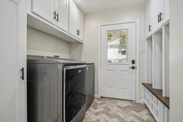 a view of a kitchen with refrigerator and window