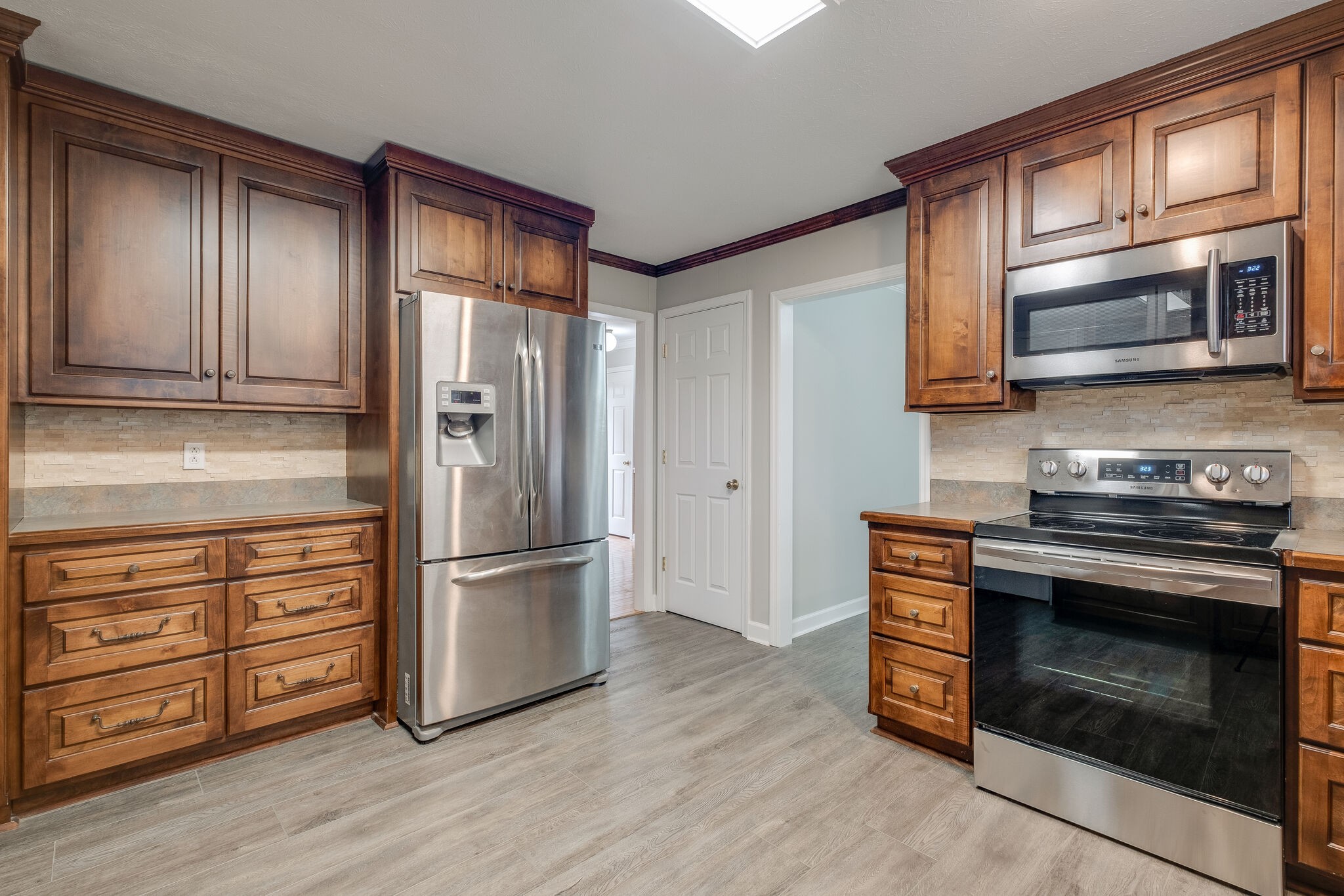 8860 Lyles Road Lyles, TN 37098 - Photo 13 of 36 a kitchen with stainless steel appliances wooden cabinets and a stove top oven