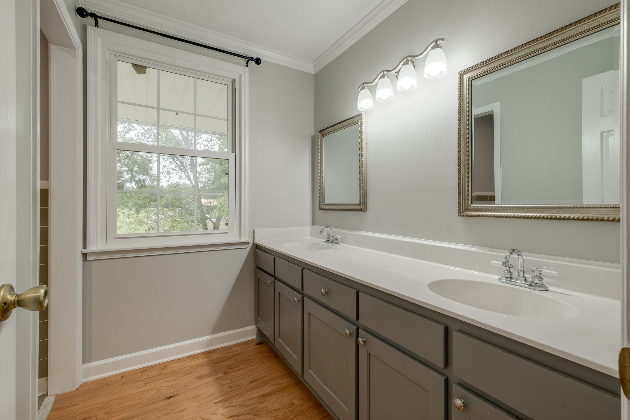 8860 Lyles Road Lyles, TN 37098 - Photo 20 of 36 a bathroom with a double vanity sink and a mirror