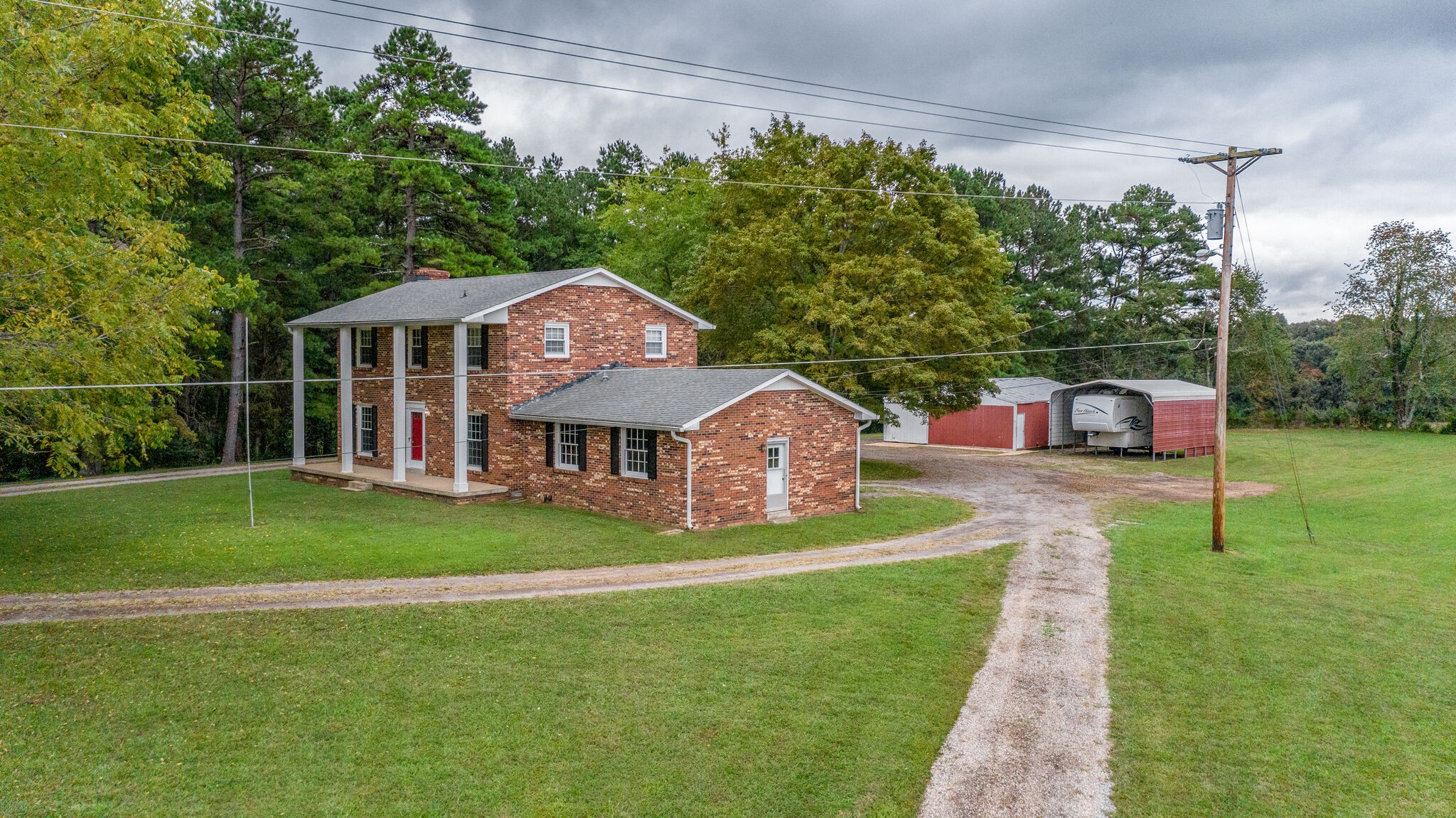 8860 Lyles Road Lyles, TN 37098 - Photo 3 of 36 a front view of a house with a yard table and chairs