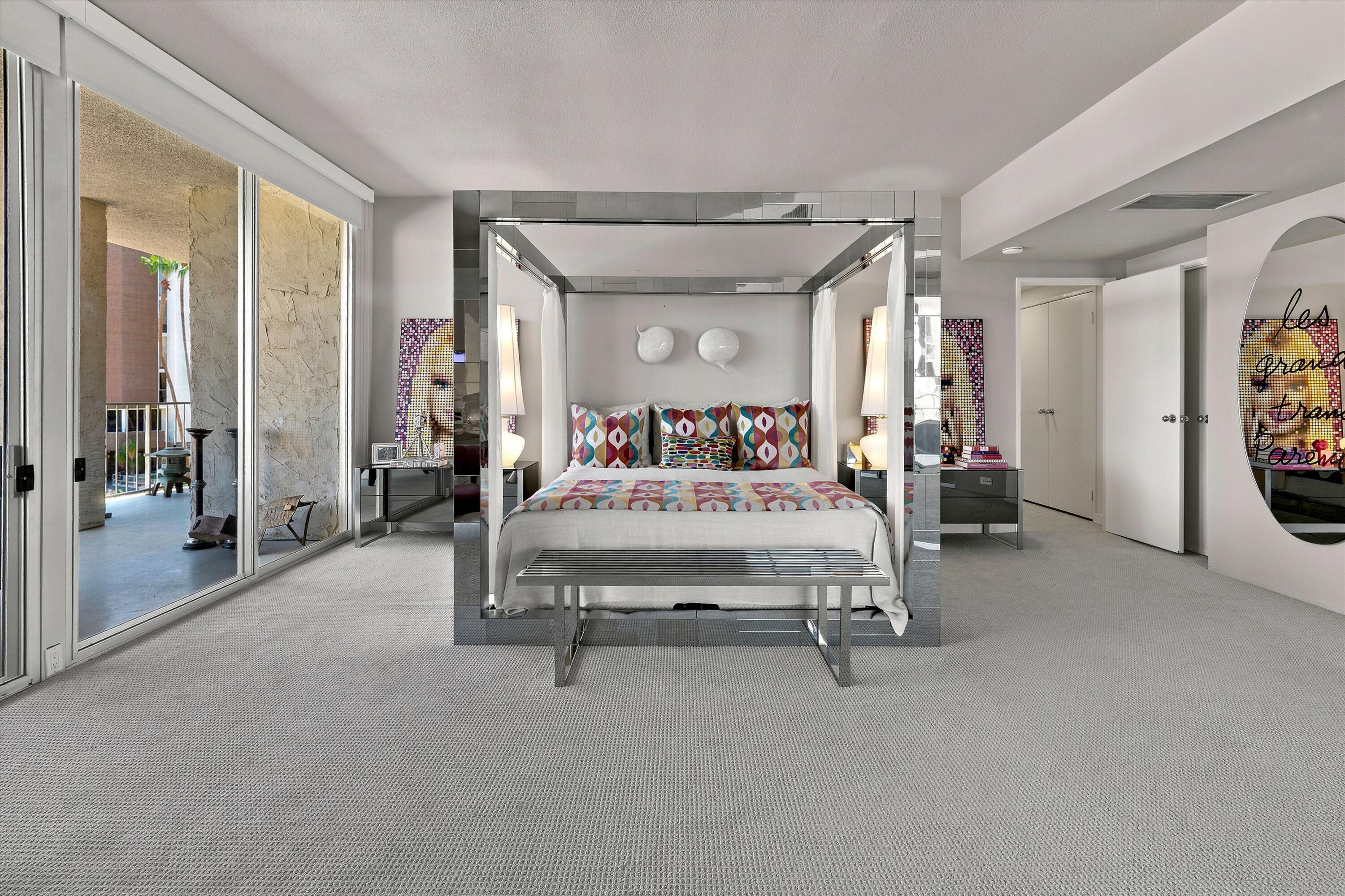 899 Island Drive, Unit 304 Rancho Mirage, CA 92270 - Photo 17 of 30 a bedroom with furniture and a large window