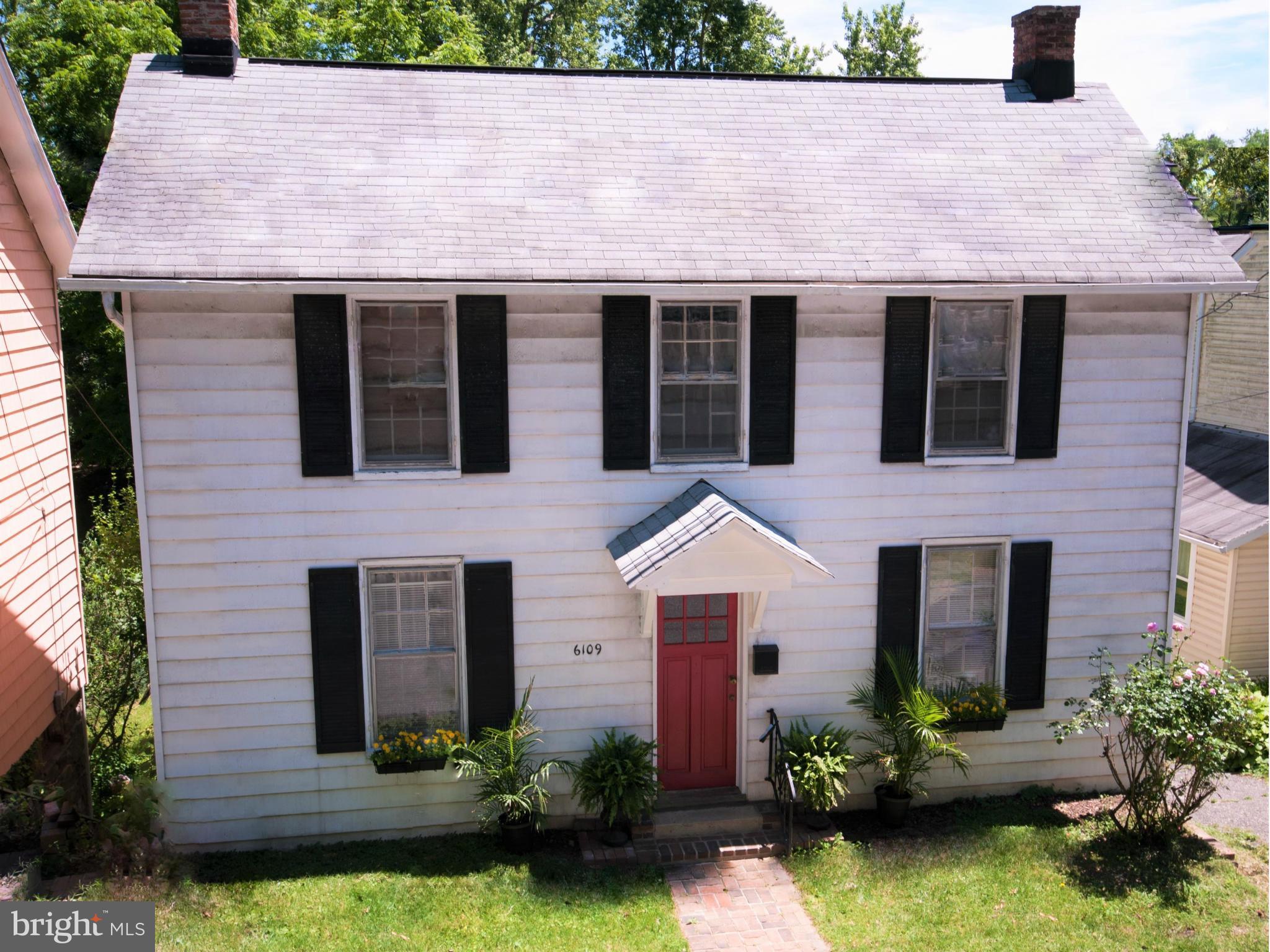 6109 Falls Road Baltimore, MD 21209 - Photo 2 of 26 a front view of a house with garden