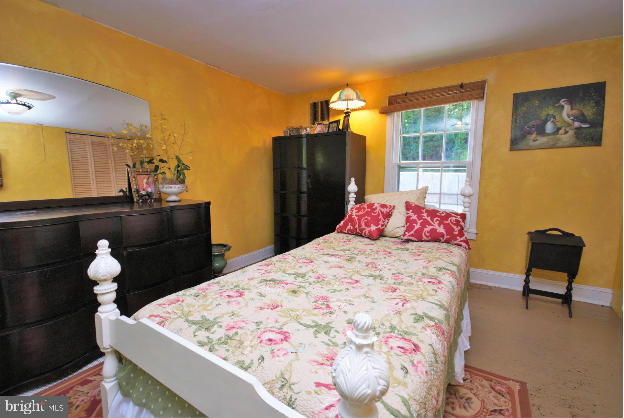 6109 Falls Road Baltimore, MD 21209 - Photo 16 of 26 a bedroom with a bed and teddy bear on bed