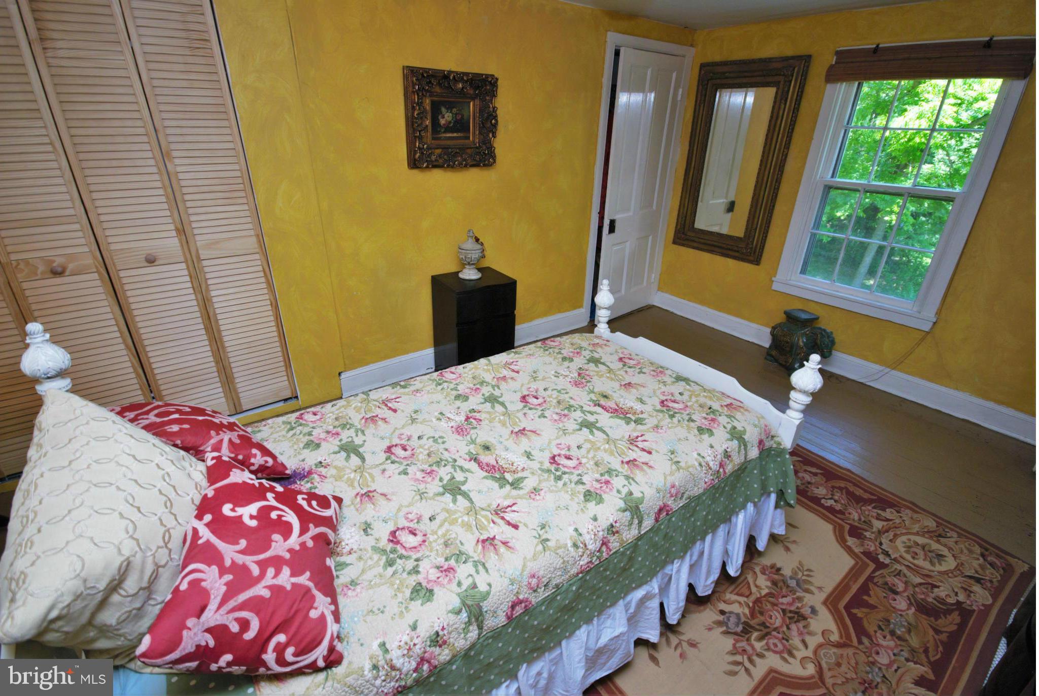 6109 Falls Road Baltimore, MD 21209 - Photo 17 of 26 a bedroom with a bed and wooden floor