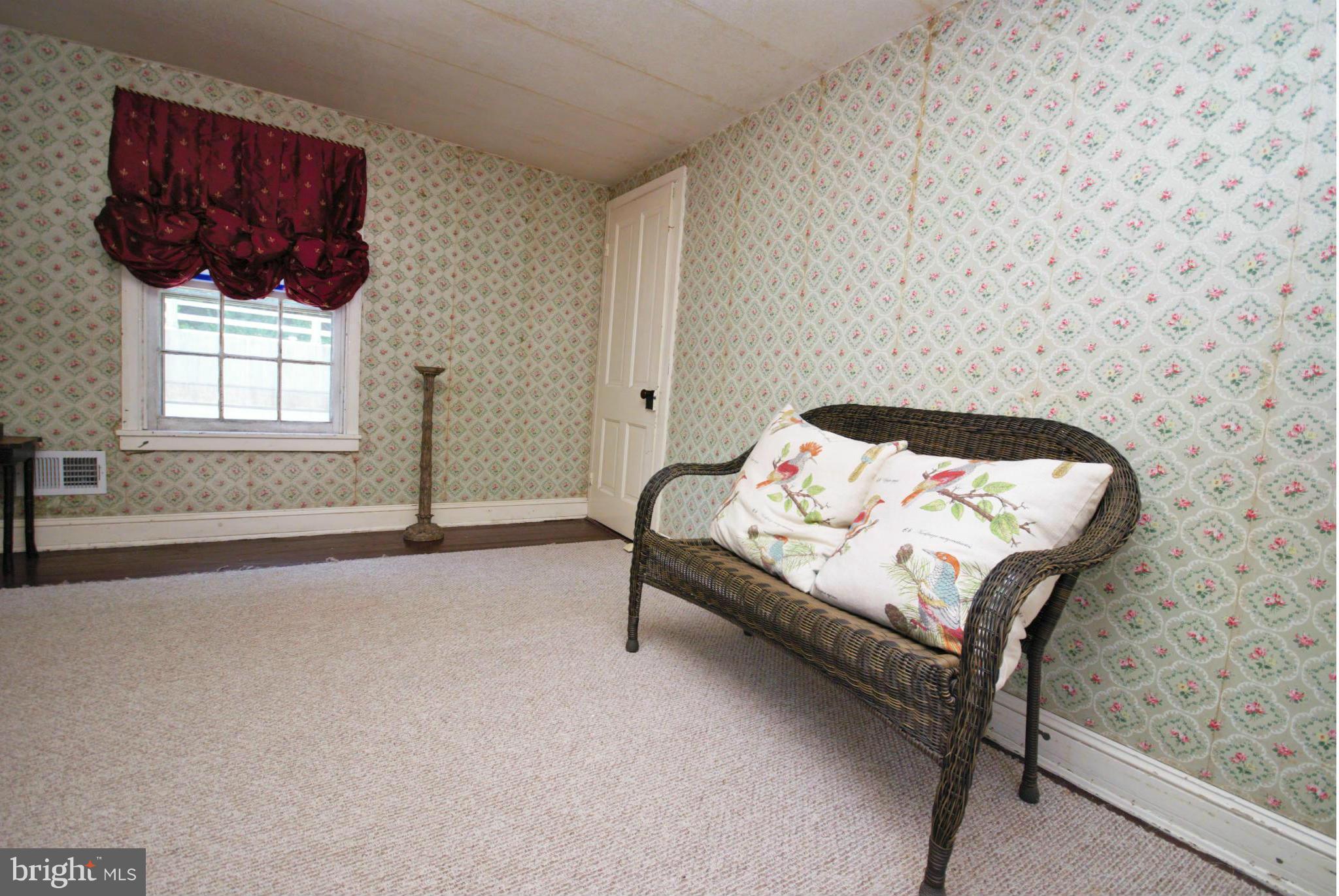 6109 Falls Road Baltimore, MD 21209 - Photo 18 of 26 a bedroom with a bed a lamp and window
