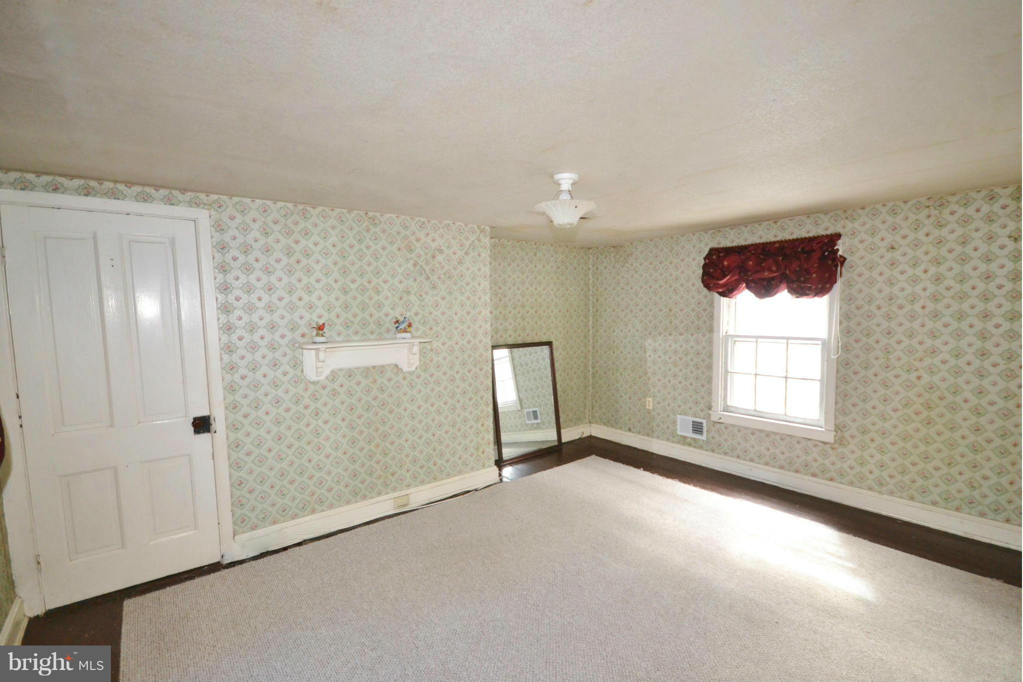 6109 Falls Road Baltimore, MD 21209 - Photo 19 of 26 a view of an empty room with a window