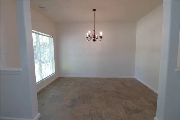 a view of a chandelier in big room and chandelier fan
